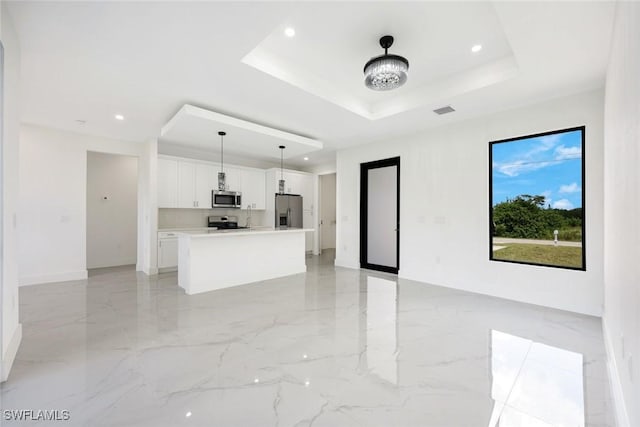 147 Partridge St, Lehigh Acres, FL 33974 - unfurnished living room featuring a tray ceiling, light marble finish flooring, and recessed lighting