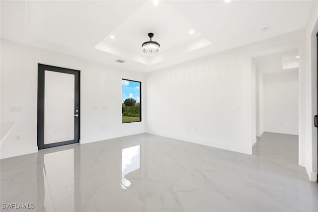 147 Partridge St, Lehigh Acres, FL 33974 - unfurnished room with marble tiled floors, recessed lighting, and a raised ceiling