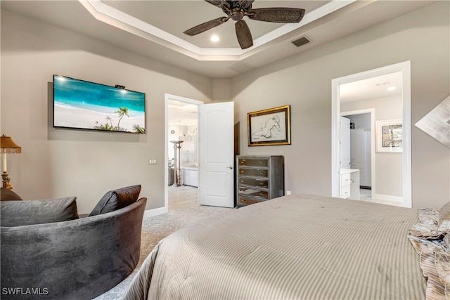 7478 Winding Cypress Dr, Naples, FL 34114 - bedroom with ensuite bath, a tray ceiling, light carpet, and a ceiling fan