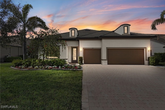 7478 Winding Cypress Dr, Naples, FL 34114 - view of front of house with an attached garage, decorative driveway, a front lawn, and stucco siding