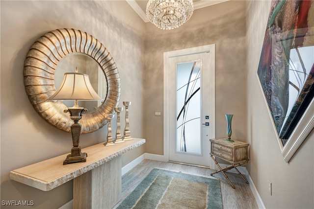 7478 Winding Cypress Dr, Naples, FL 34114 - entryway featuring healthy amount of natural light, a chandelier, wood finished floors, and ornamental molding