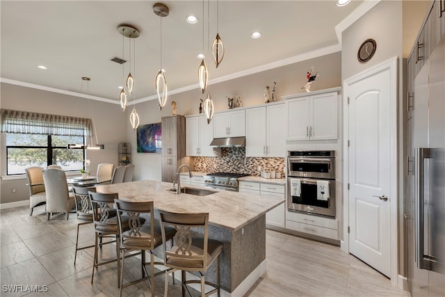 7478 Winding Cypress Dr, Naples, FL 34114 - kitchen featuring stainless steel appliances, decorative backsplash, a center island with sink, a breakfast bar area, and under cabinet range hood