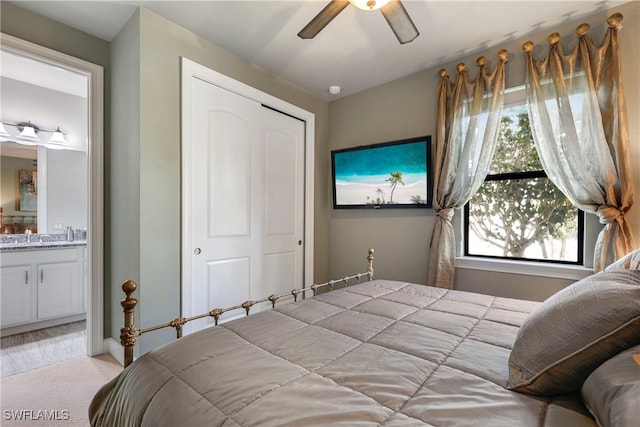 7478 Winding Cypress Dr, Naples, FL 34114 - bedroom with light colored carpet, a closet, ensuite bathroom, and ceiling fan