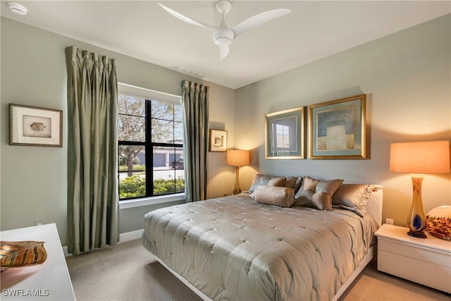 7478 Winding Cypress Dr, Naples, FL 34114 - bedroom with light colored carpet and a ceiling fan
