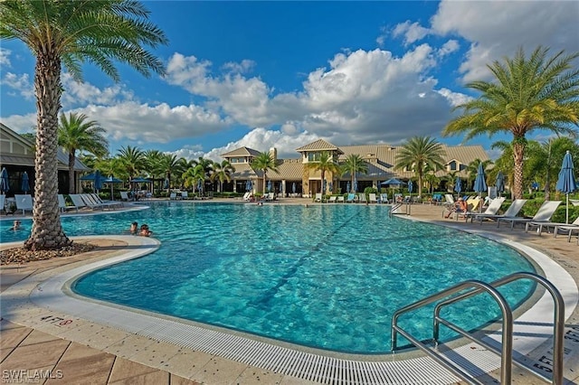 7478 Winding Cypress Dr, Naples, FL 34114 - community pool featuring a patio area