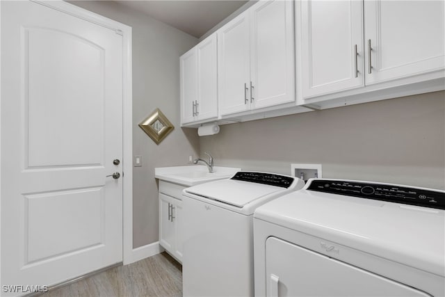 7478 Winding Cypress Dr, Naples, FL 34114 - washroom with separate washer and dryer, light wood-style floors, and cabinet space