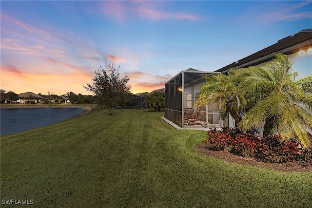 7478 Winding Cypress Dr, Naples, FL 34114 - yard at dusk featuring a water view, a yard, and glass enclosure