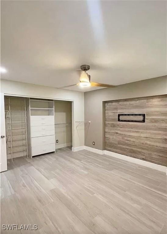1407 Alwynne Dr, Lehigh Acres, FL 33936 - unfurnished bedroom featuring wood finished floors, ceiling fan, and a closet