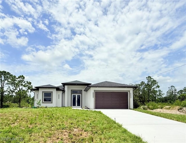 521 Johns Ave, Lehigh Acres, FL 33972 - prairie-style home featuring an attached garage, concrete driveway, stucco siding, and a front lawn