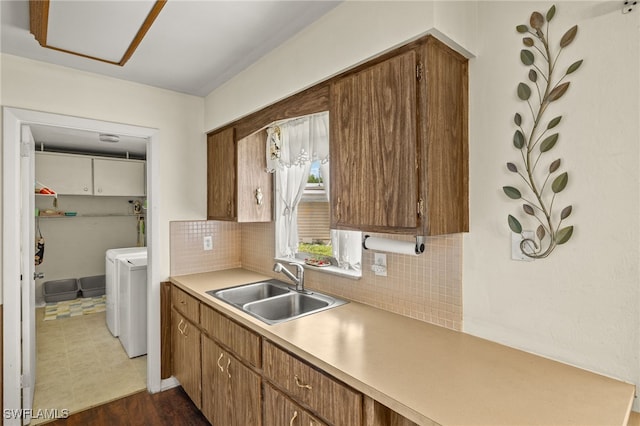 326 Canyon Dr N, Lehigh Acres, FL 33936 - kitchen featuring separate washer and dryer, tasteful backsplash, light countertops, and brown cabinetry