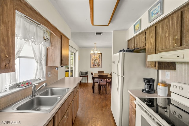 326 Canyon Dr N, Lehigh Acres, FL 33936 - kitchen featuring white electric stove, brown cabinetry, a chandelier, and dark wood finished floors