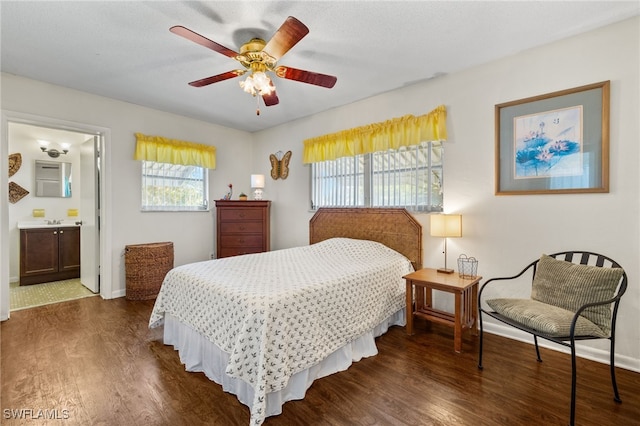 326 Canyon Dr N, Lehigh Acres, FL 33936 - bedroom featuring dark wood-type flooring, connected bathroom, and ceiling fan