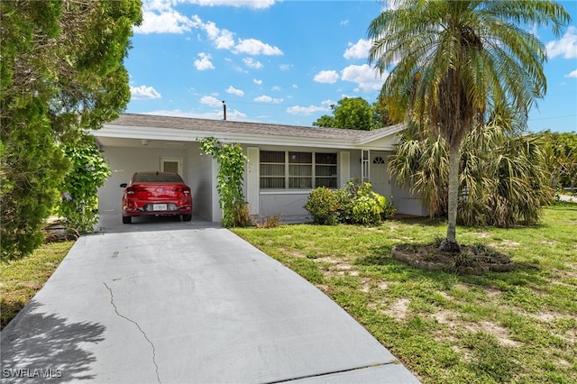326 Canyon Dr N, Lehigh Acres, FL 33936 - single story home featuring a front lawn, driveway, a carport, and stucco siding