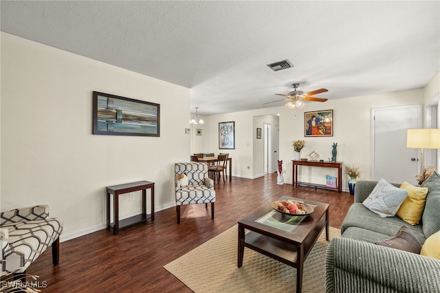 326 Canyon Dr N, Lehigh Acres, FL 33936 - living area with dark wood-style floors, a ceiling fan, a textured ceiling, and a chandelier