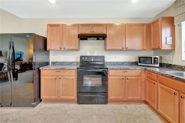 6425 Estero Bay Dr, Fort Myers, FL 33908 - kitchen with black appliances, under cabinet range hood, dark countertops, and light tile patterned flooring
