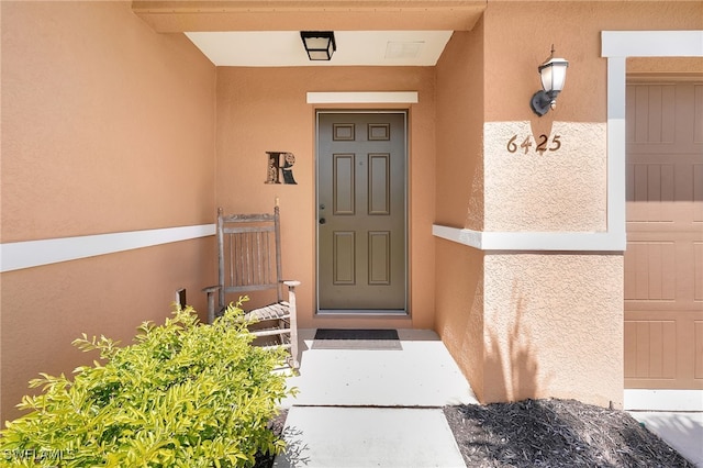 6425 Estero Bay Dr, Fort Myers, FL 33908 - doorway to property featuring stucco siding
