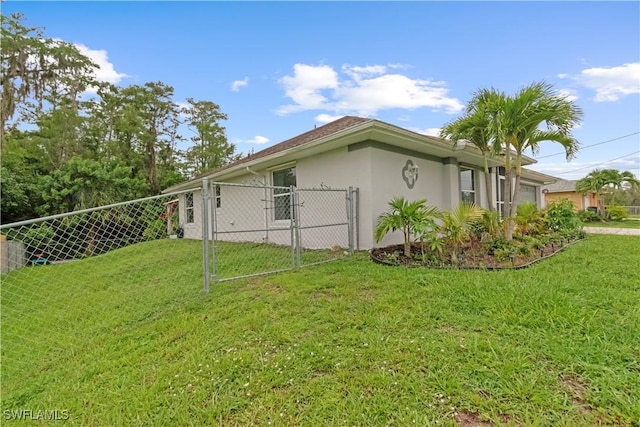 424 La Perouse St, Lehigh Acres, FL 33974 - view of home's exterior with an attached garage, stucco siding, and a gate