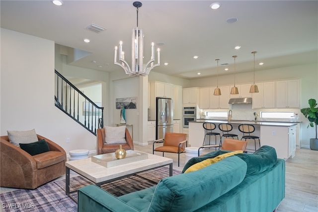 4442 Battlecreek Way, Ave Maria, FL 34142 - living area with recessed lighting, a chandelier, light wood-type flooring, and stairs