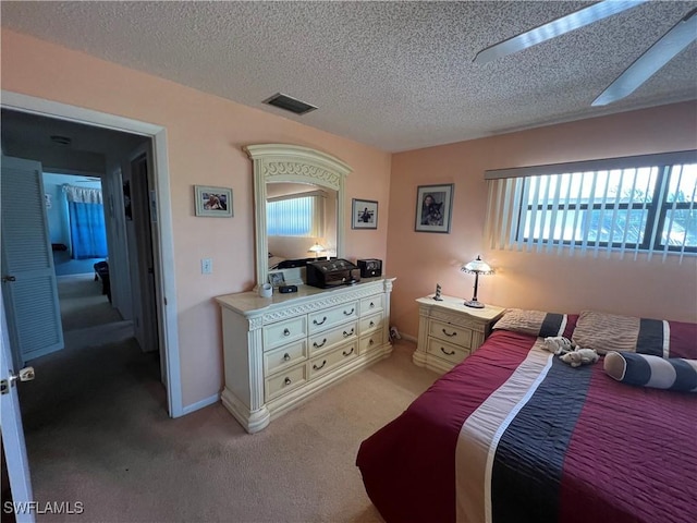 2127 SW Pine Ln Unit 3, Cape Coral, FL 33991 - bedroom featuring a textured ceiling and light carpet