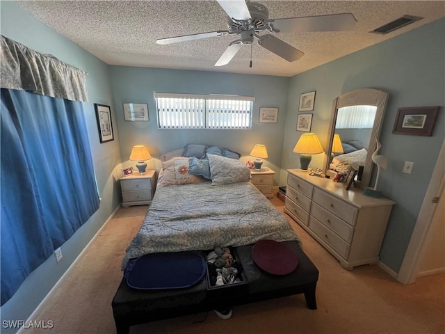 2127 SW Pine Ln Unit 3, Cape Coral, FL 33991 - bedroom with light carpet, a textured ceiling, and ceiling fan