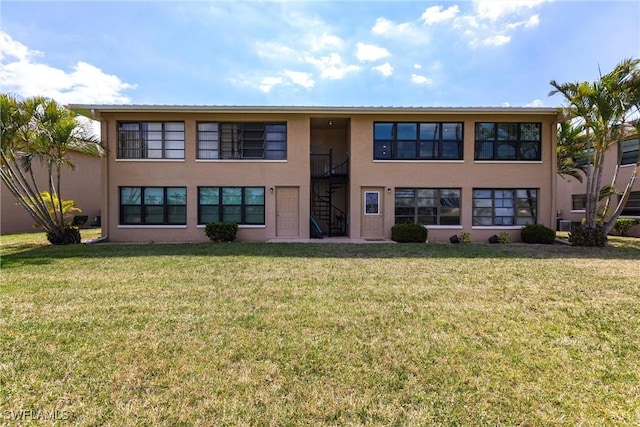 2127 SW Pine Ln Unit 3, Cape Coral, FL 33991 - view of front of property with stairway, stucco siding, and a front yard