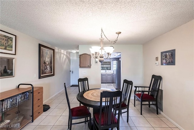 2127 SW Pine Ln Unit 3, Cape Coral, FL 33991 - dining space featuring a chandelier, light tile patterned floors, and a textured ceiling