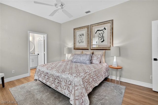 7637 Mulberry Ln, Naples, FL 34114 - bedroom with light wood-type flooring, a ceiling fan, and ensuite bathroom