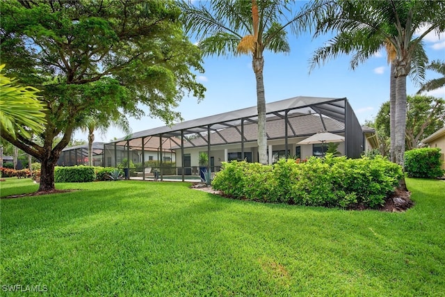 7637 Mulberry Ln, Naples, FL 34114 - back of property with a lawn and glass enclosure