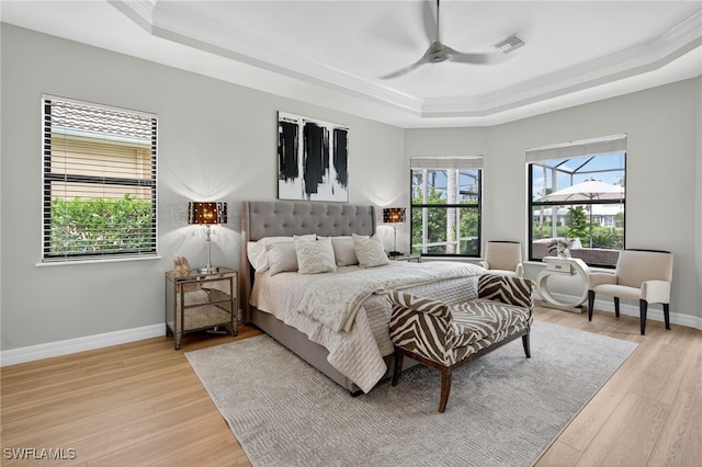 7637 Mulberry Ln, Naples, FL 34114 - bedroom featuring a tray ceiling, crown molding, light wood-type flooring, and ceiling fan