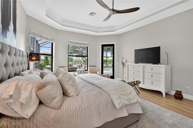 7637 Mulberry Ln, Naples, FL 34114 - bedroom featuring ornamental molding, access to exterior, a raised ceiling, wood finished floors, and a ceiling fan
