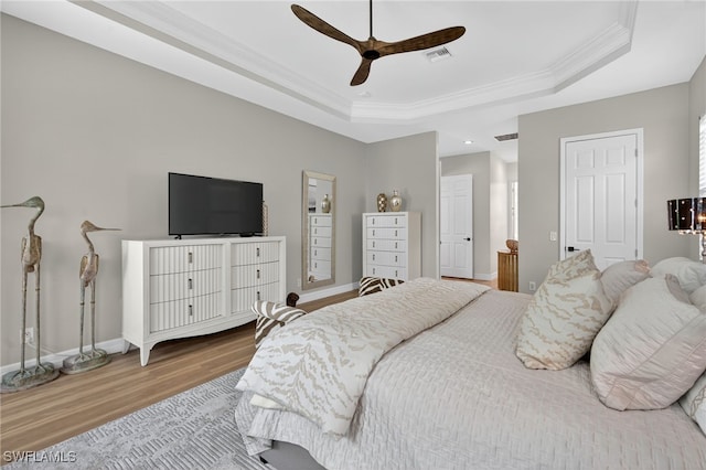 7637 Mulberry Ln, Naples, FL 34114 - bedroom featuring a raised ceiling, wood finished floors, crown molding, and ceiling fan