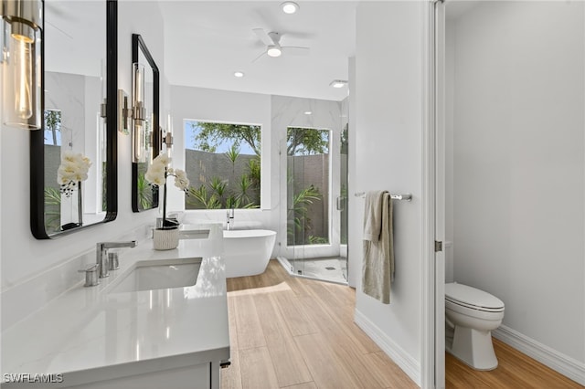 7637 Mulberry Ln, Naples, FL 34114 - full bathroom with double vanity, wood finished floors, a ceiling fan, a shower stall, and recessed lighting