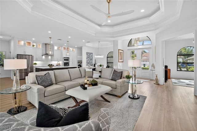 7637 Mulberry Ln, Naples, FL 34114 - living room with ceiling fan, light wood-style floors, a raised ceiling, recessed lighting, and a high ceiling