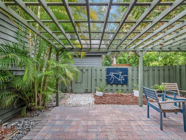1271 Solana Rd Unit E4, Naples, FL 34103 - view of patio / terrace featuring a gate and a pergola