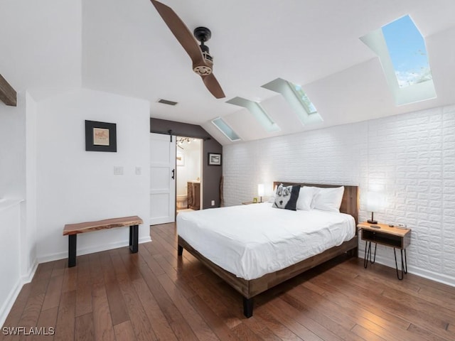 1271 Solana Rd Unit E4, Naples, FL 34103 - bedroom featuring a skylight, brick wall, hardwood / wood-style flooring, lofted ceiling, and ensuite bath