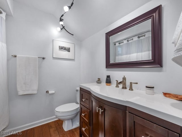 1271 Solana Rd Unit E4, Naples, FL 34103 - bathroom with lofted ceiling, vanity, and wood finished floors