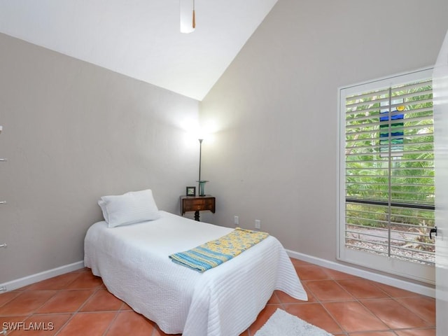 1271 Solana Rd Unit E4, Naples, FL 34103 - tiled bedroom featuring vaulted ceiling and multiple windows