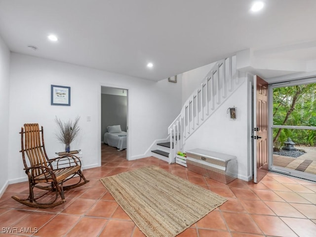 1271 Solana Rd Unit E4, Naples, FL 34103 - sitting room with light tile patterned floors, stairs, and recessed lighting