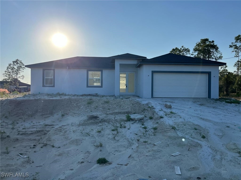 716 Joponica Ave S, Lehigh Acres, FL 33974 - ranch-style house featuring stucco siding and an attached garage