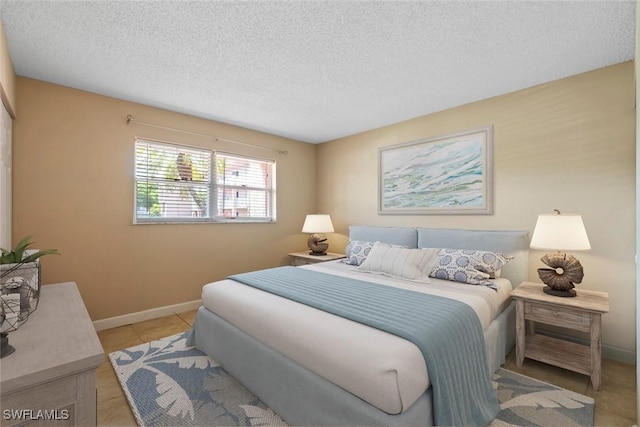 170 Turtle Lake Ct Unit 109, Naples, FL 34105 - bedroom featuring a textured ceiling and tile patterned flooring