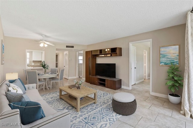 170 Turtle Lake Ct Unit 109, Naples, FL 34105 - living area with a textured ceiling and a ceiling fan