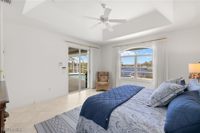 3615 Tripoli Blvd, Punta Gorda, FL 33950 - bedroom with a raised ceiling, a water view, access to outside, light tile patterned floors, and multiple windows
