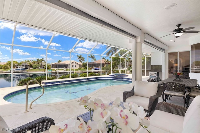 3615 Tripoli Blvd, Punta Gorda, FL 33950 - view of swimming pool featuring ceiling fan, a patio area, a pool with connected hot tub, a water view, and glass enclosure