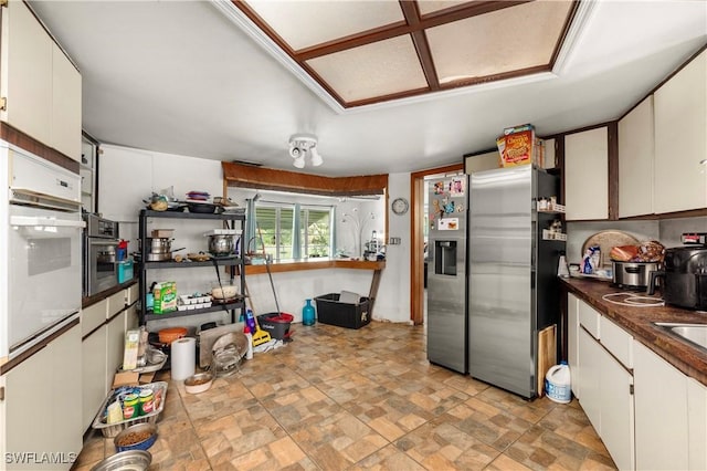 17041 Tarpon Way N, Fort Myers, FL 33917 - kitchen with stainless steel refrigerator with ice dispenser, white cabinets, dark countertops, and stone finish floors