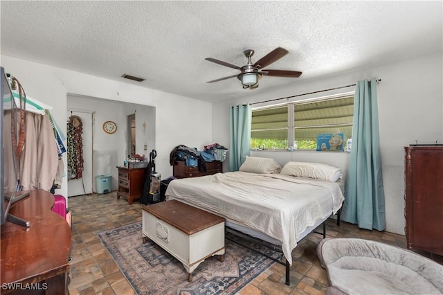 17041 Tarpon Way N, Fort Myers, FL 33917 - bedroom featuring a textured ceiling, a ceiling fan, and stone finish flooring