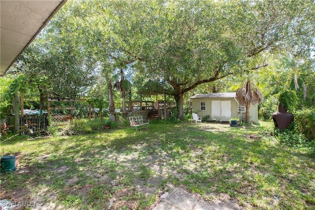 17041 Tarpon Way N, Fort Myers, FL 33917 - view of green lawn with a storage unit