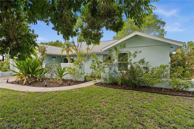 770 Wilson Ave, Fort Myers, FL 33919 - ranch-style home featuring a front lawn and stucco siding