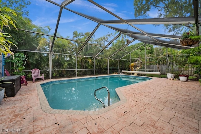 770 Wilson Ave, Fort Myers, FL 33919 - outdoor pool featuring a patio area, a lanai, and a fenced backyard