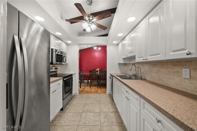 770 Wilson Ave, Fort Myers, FL 33919 - kitchen with stainless steel appliances, a ceiling fan, recessed lighting, decorative backsplash, and a tray ceiling
