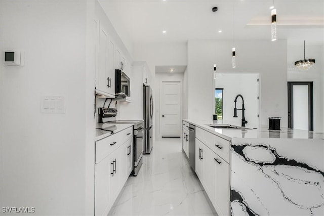 1220 Edward Ave, Lehigh Acres, FL 33972 - kitchen featuring appliances with stainless steel finishes, white cabinetry, light marble finish floors, pendant lighting, and recessed lighting